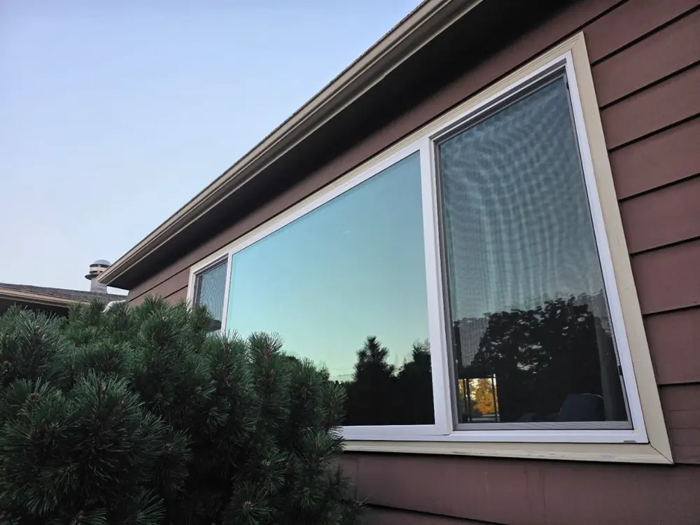 Clean residential windows reflecting the sky after professional service